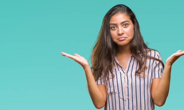 istock Young beautiful arab woman over isolated background clueless and confused expression with arms and hands raised. Doubt concept. 1043317088