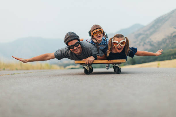 istock Young Kids and Dad Flying on a Press Cart 1043320416