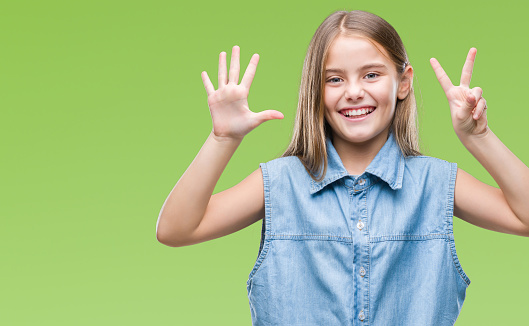 Young beautiful girl over isolated background showing and pointing up with fingers number seven while smiling confident and happy.