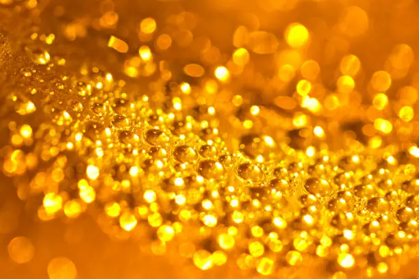 Abstract macro of water drops over golden background