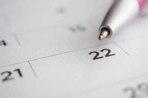 istock Calendar page with pen point at 22nd date 1043338348