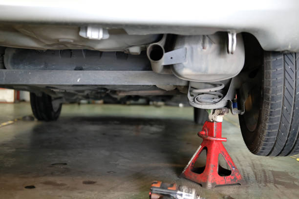 istock car lift up for shock absorber & spring replacement in auto repair garage 1043341012