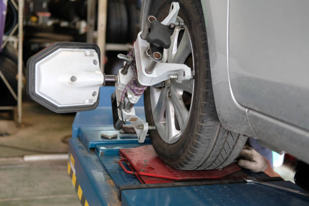 istock car tyre clamped with  aligner reflector adjustment tool for wheel alignment check in auto garage service 1043341044