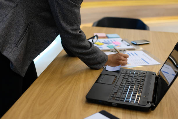 istock businesswoman analyze financial graph chart at workplace. woman working with plan report document 1043341090