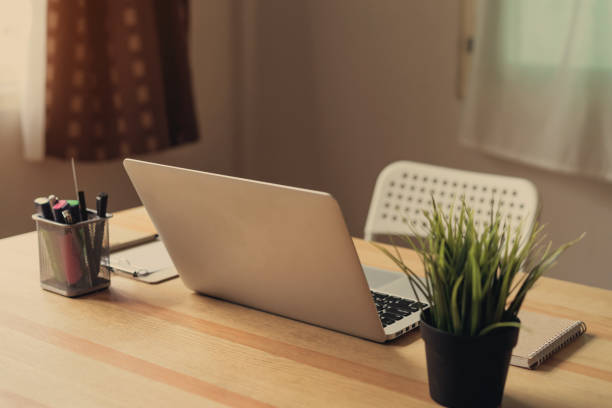 istock Laptop on table in the office room background, for graphics display montage. Take your screen to put on advertising. 1043341458