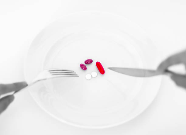 istock Pills on a plate with fork and knife. Diet concept. 1043341460