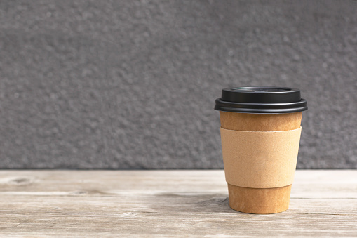 Cardboard take out cup of coffee or tea. Place for your logo and copy-space for text.