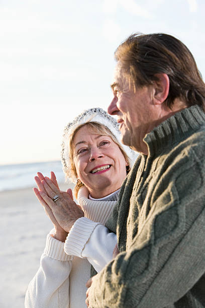 istock Senior couple in sweaters together on beach 104336507