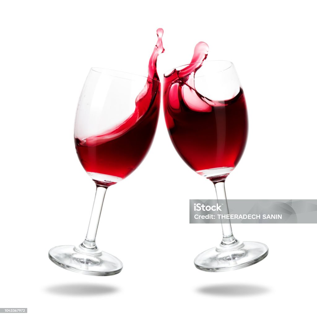 Cheering wine Cheers red wine with splash out of glass isolated on white background. Wine Stock Photo