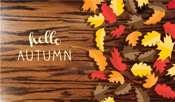 istock Hello Autumn greeting design on wooden background with fall leaves 1043370814