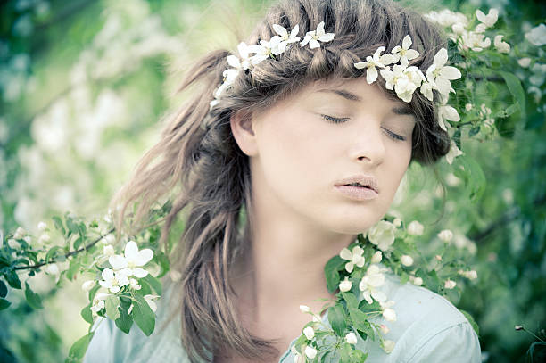 Girl in spring flowers stock photo