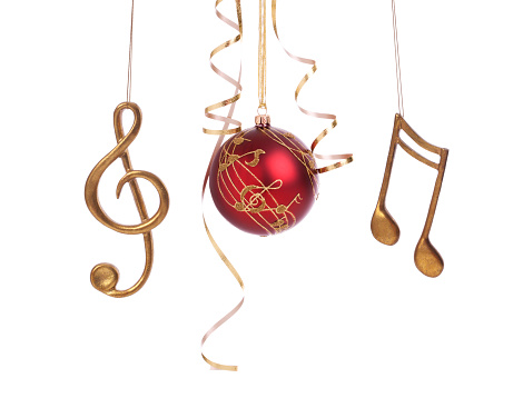 Christmas holiday set of elegant musical baubles and decorations with curled gold ribbon isolated on white