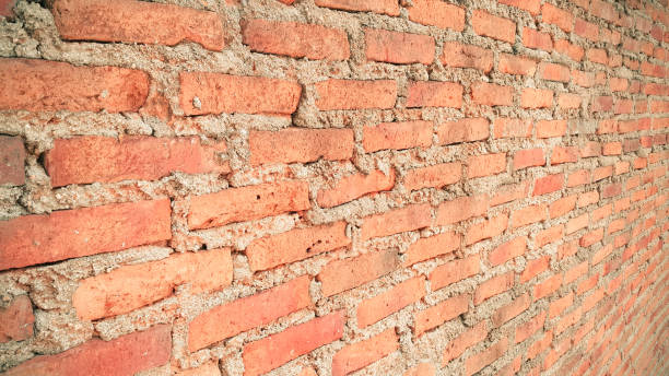 istock Side view of old orange vintage brick wall 1043403554