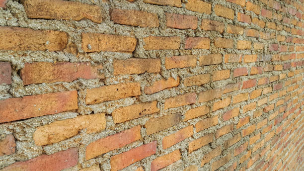 istock Side view of old orange vintage brick wall 1043403648