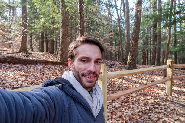 istock A hiker wearing winter clothes smiles 1043408120