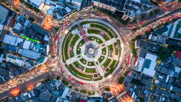 Aerial top view road roundabout with car lots,   Aerial view road traffic in city at night. Aerial top view road roundabout with car lots,   Aerial view road traffic in city at night. traffic circle photos stock pictures, royalty-free photos & images