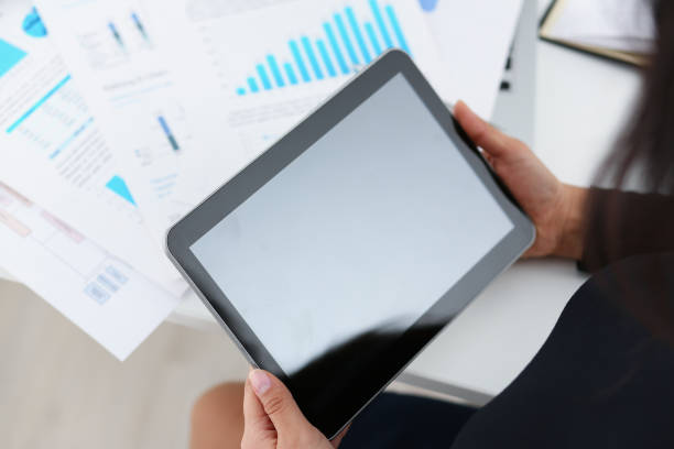 istock businesswoman study documents hold tablet in her hands closeup 1043420954