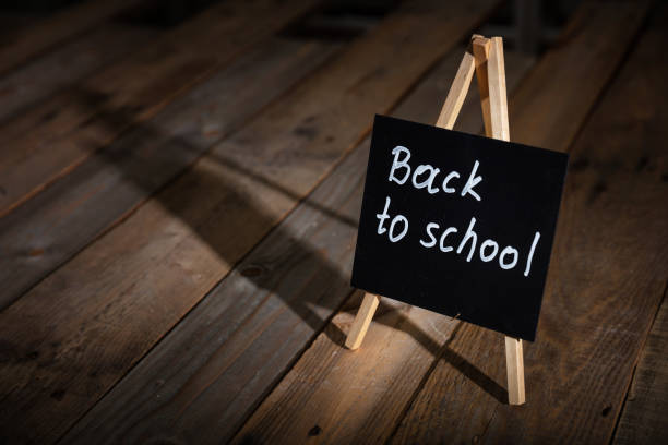 istock Blackboard with back to school text, dark wooden background, copy space 1043431696