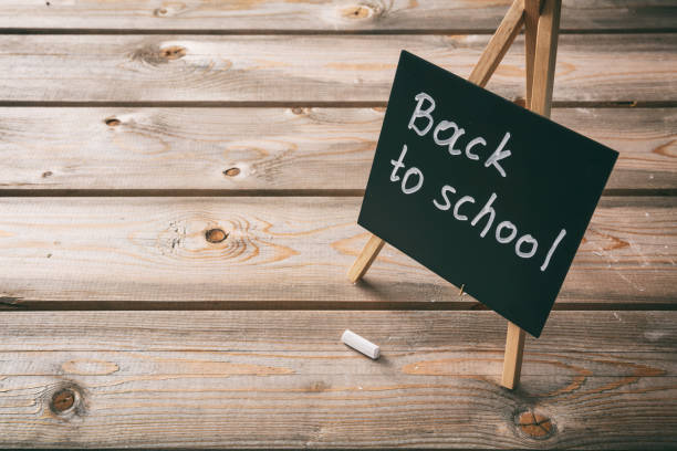 istock Blackboard with back to school text, dark wooden background, copy space 1043431720