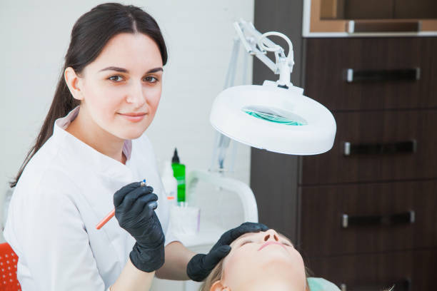 istock Beautician cosmetologist applying permanent makeup 1043431888