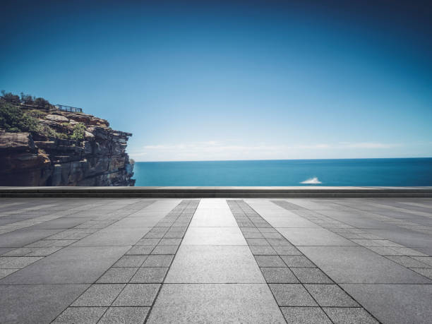 Scenic view of sea and cliff against sky stock photo