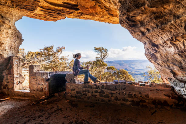 Sitting in a cliff side cave views over mountain ranges