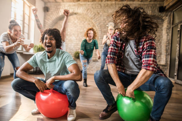 istock Cheerful men having fun during space hopper at casual office. 1043440900