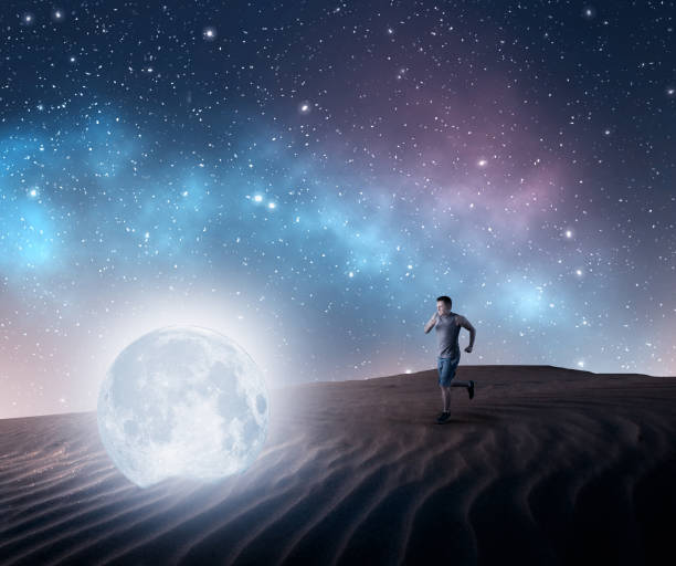 istock Man running to a moon fallen in the desert. 1043441616