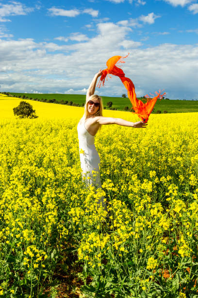 istock Fun loving woman in fields of canola 1043441638