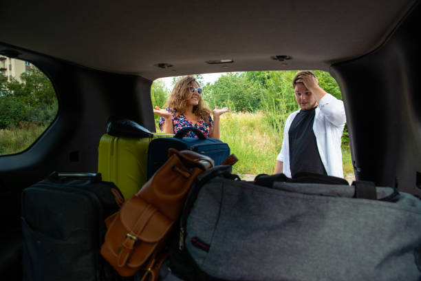 istock couple put bags in car trunk 1043443778