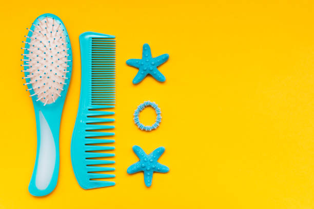A set of combs, a hair band and a hair clip on a yellow background A set of combs, a hair band and a hair clip on a yellow background. Top View hair band stock pictures, royalty-free photos & images