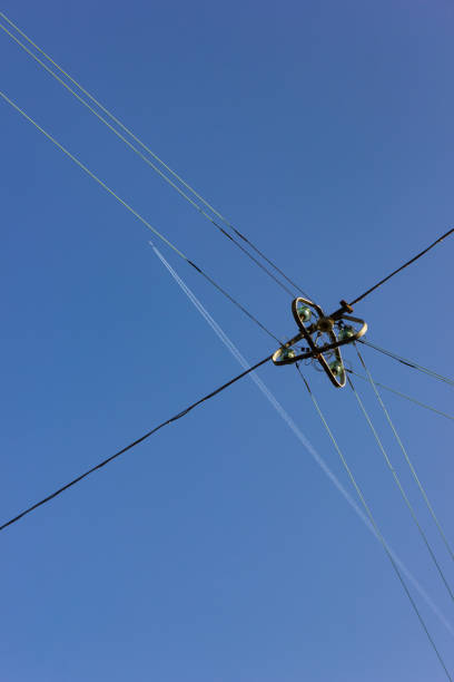 istock electric streetlamp hanging on cable before blue summer sunny sky 1043452898