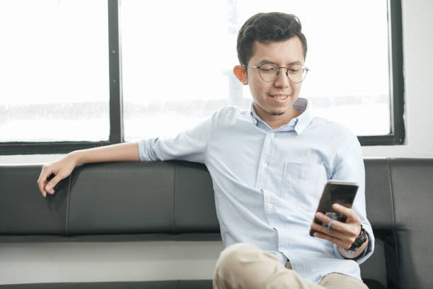 istock Southeast Asia Young Man Playing Smartphone 1043452910