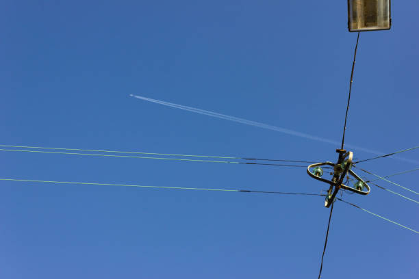 istock electric streetlamp hanging on cable before blue summer sunny sky 1043452926