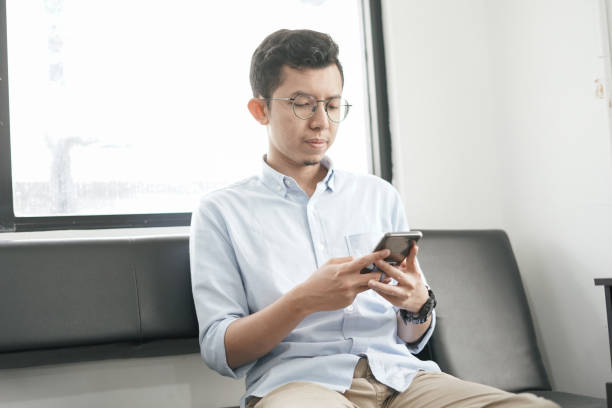 istock Southeast Asia Young Man Playing Smartphone 1043452932