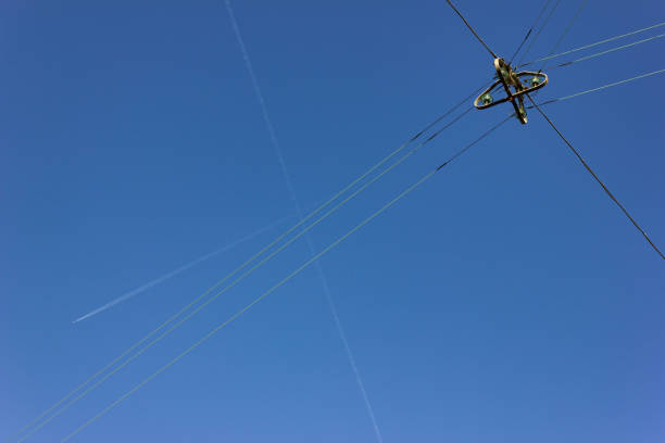 istock electric streetlamp hanging on cable before blue summer sunny sky 1043453124