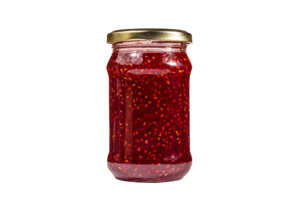 istock Raspberry jam in glass jar isolated on white background 1043471338