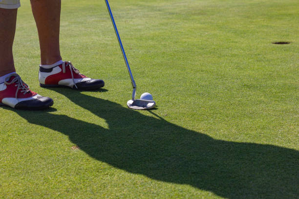 istock playing golf on summer day and green lawn 1043476104