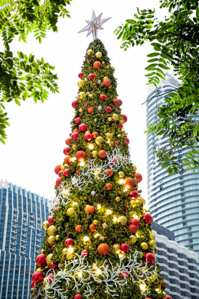 istock Decorated outdoor shiny Christmas tree with lights at night 1043476714