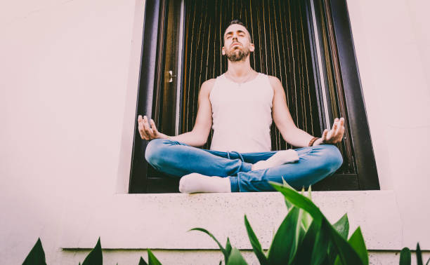 istock Young man practicing yoga posture called lotus flower 1043476972