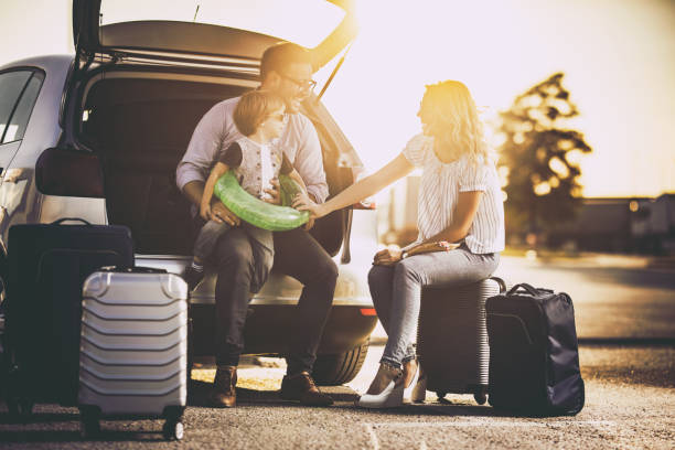 istock Young happy family talking before a trip by car. 1043480052