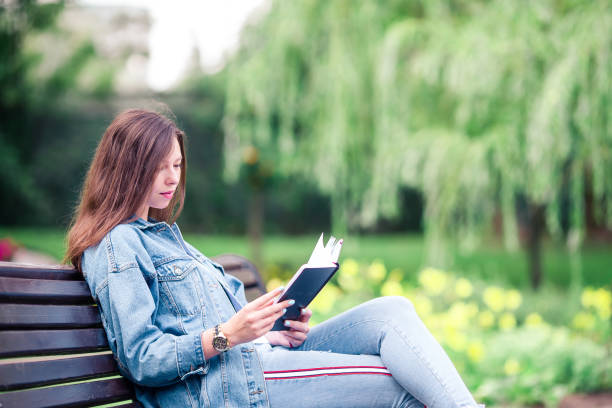 istock Relaxed young woman reading book 1043486478