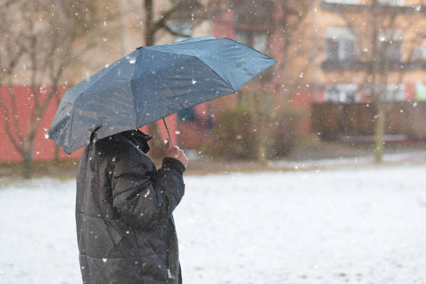 istock Young man walking in the snowfall 1043486768