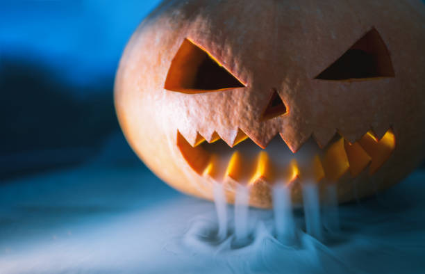 istock Scary Halloween Pumpkin looking through the smoke 1043487596