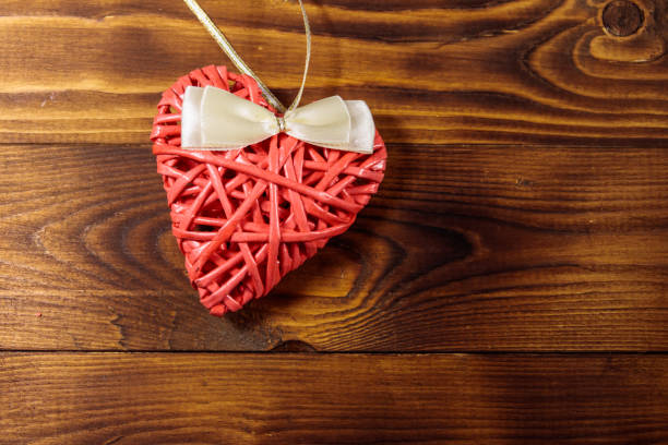 istock Pink heart on wooden background 1043490138