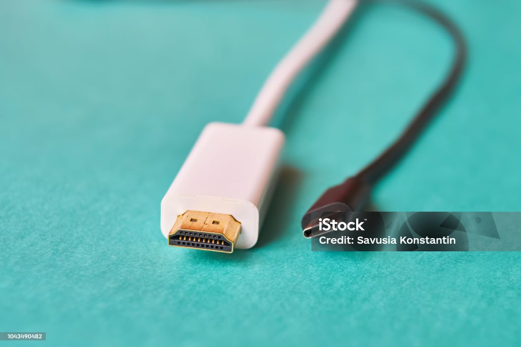 Closeup of HDMI and type C cable. Closeup of HDMI and type C cables on blue background Cable Stock Photo