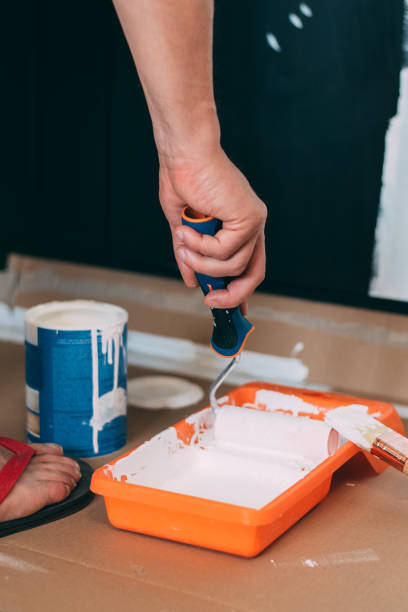 istock Man hands painting with a roller 1043497090