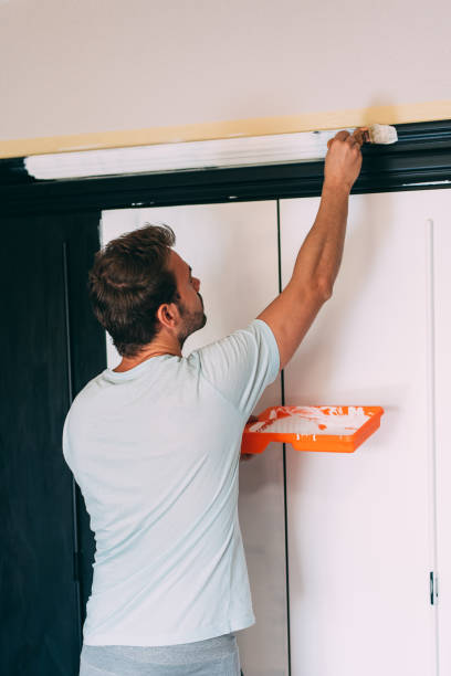 istock Man painting a wardrobe 1043497116