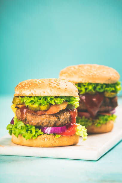 istock Homemade hamburgers on blue background 1043497342