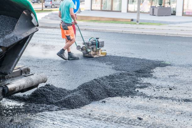 istock Road workers compact the asphalt with a vibrating rammer on the road, Germany 1043497660